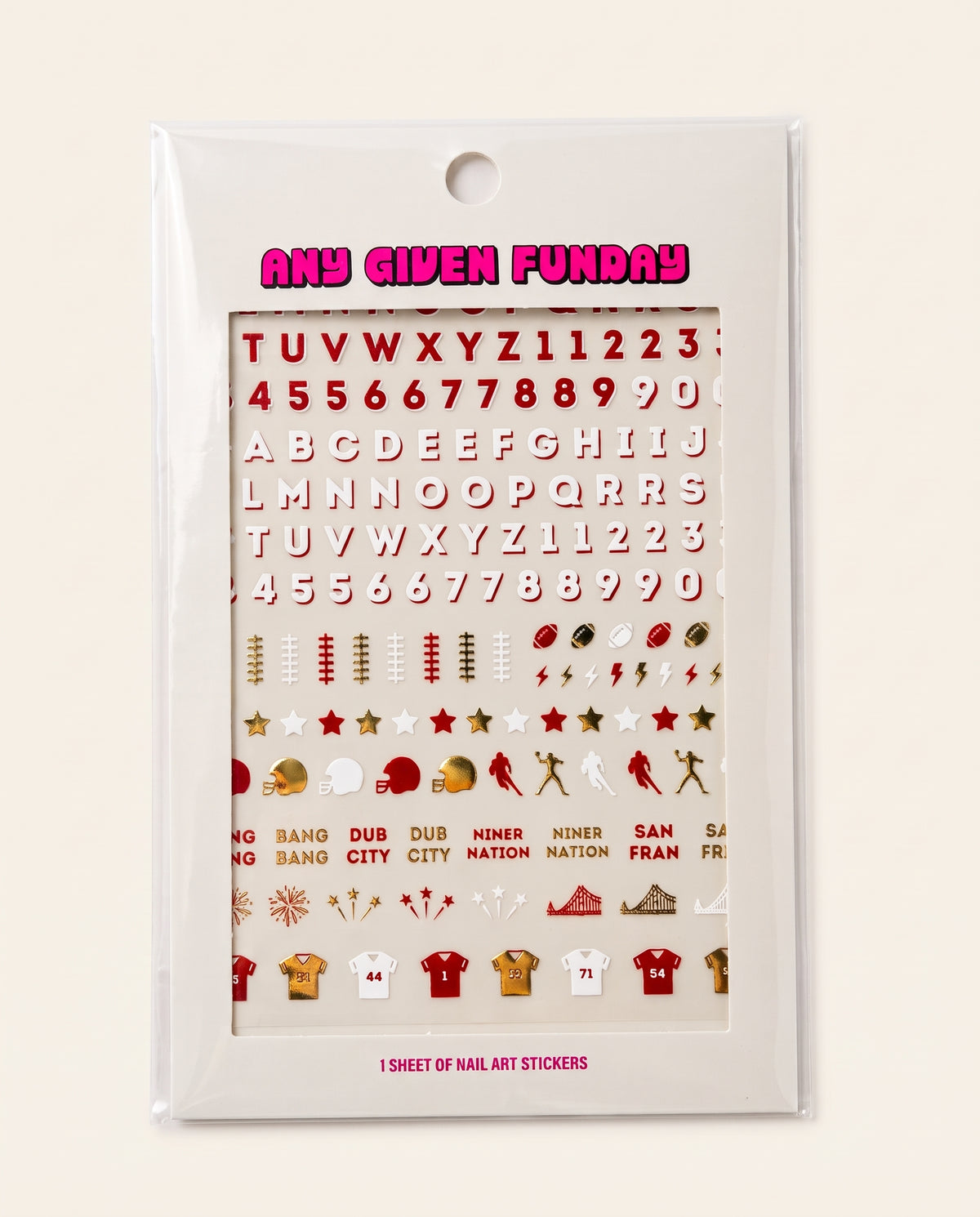 A sheet of nail art stickers in a clear plastic sleeve, featuring red and gold sports-themed stickers including footballs, helmets, players, and text such as 'ANY GIVEN FUNDAY' and team names on a white backing card.