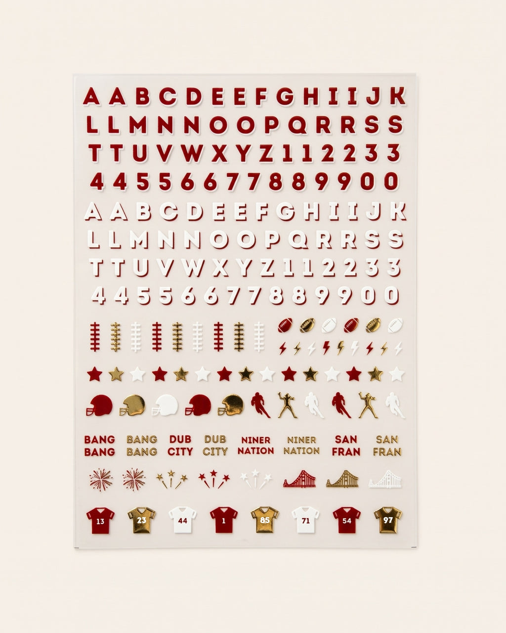 A sheet nail stickers featuring red and gold sports-themed cutouts on a light beige background, including letters, numbers, football motifs, team logos, and jerseys.