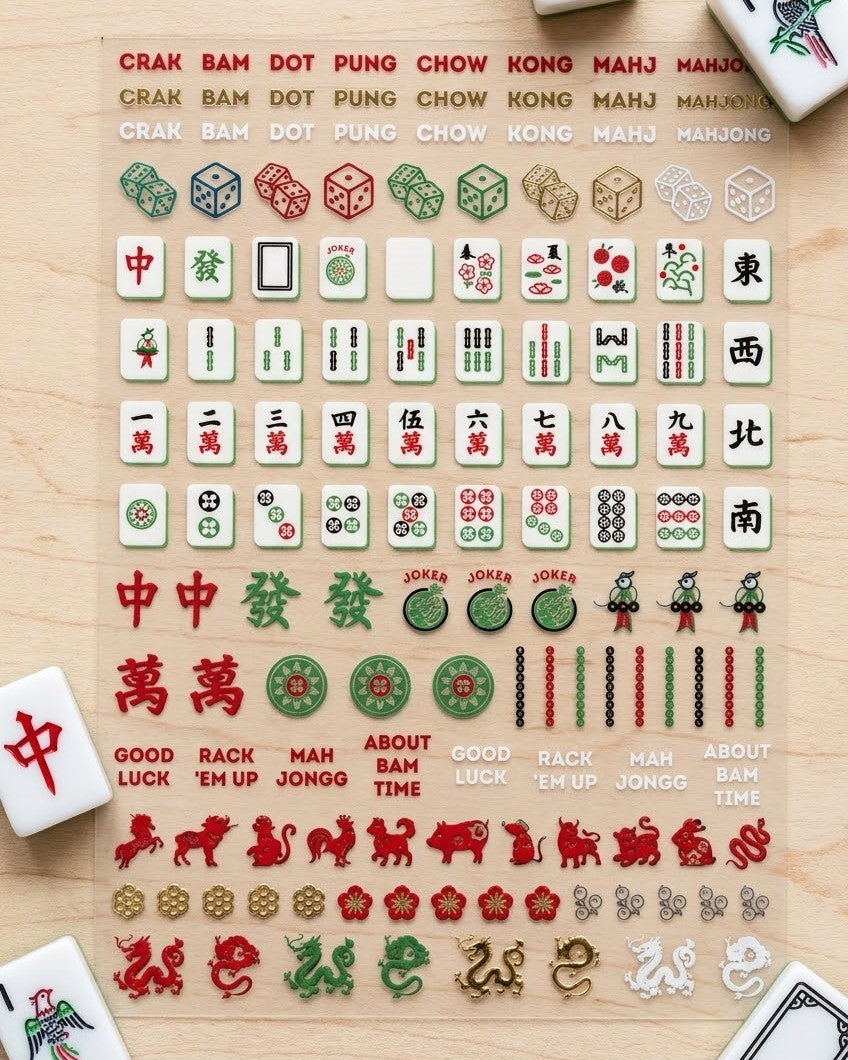 Mahjong nail art sticker sheet on a wood table with mahjong tiles: suits, winds, dragons, jokers, dice, zodiac animals, and phrases like Rack 'Em Up and About Bam Time